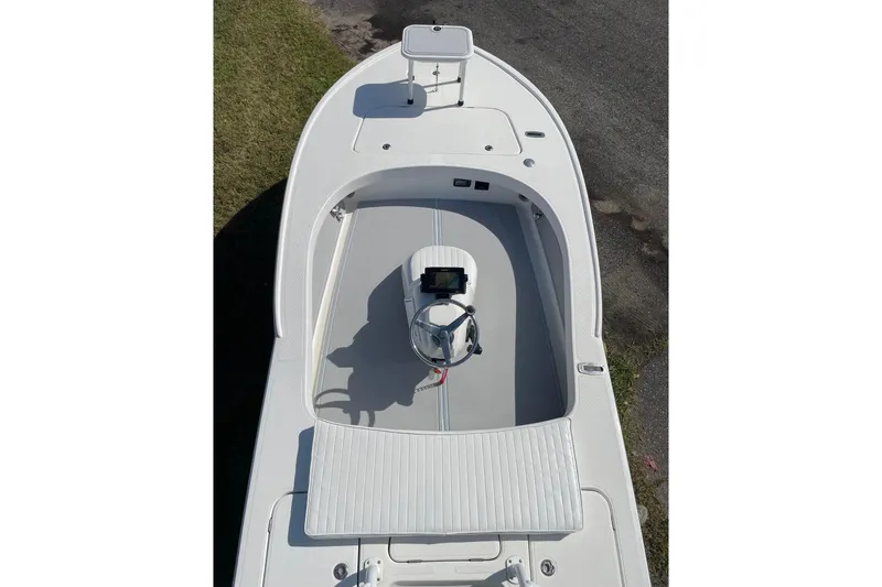 Slide: The Image of 2006 Chaos 16 Bonefish boat, top view, showcasing deck and steering console. - 7