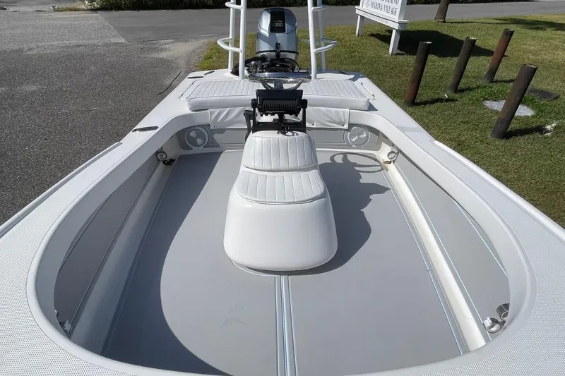 Slide: The Image of 2006 Chaos 16 Bonefish boat interior with seating and steering console. - 8