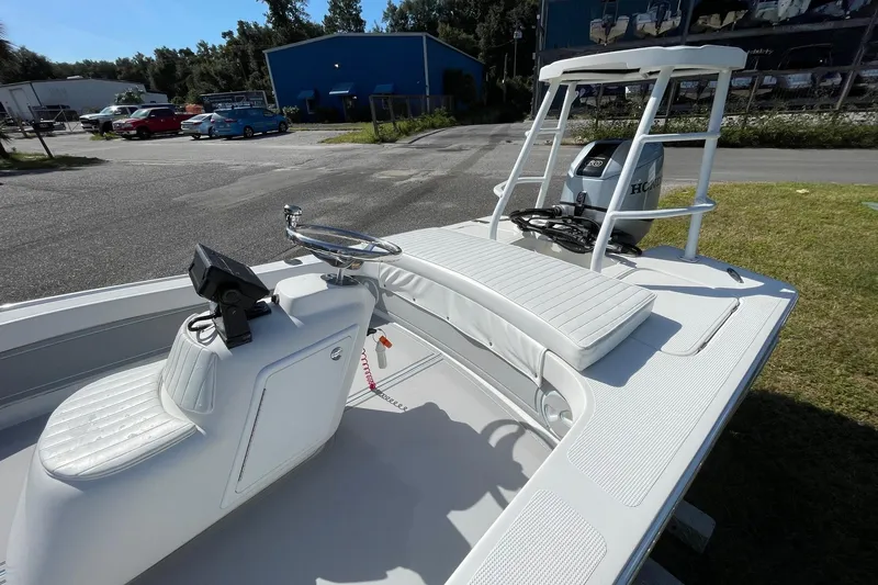 Slide: The Image of 2006 Chaos 16 Bonefish boat with steering console and Honda engine, parked outdoors. - 9