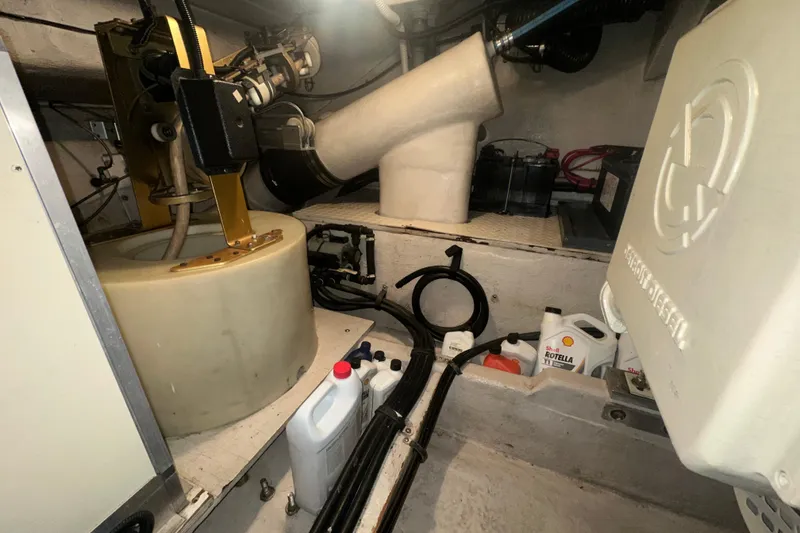 Slide: The Image of Engine room of 1998 Sea Ray 500 Sundancer with maintenance supplies and equipment. - 13