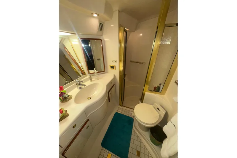 Slide: The Image of Bathroom interior of 1998 Sea Ray 500 Sundancer yacht, featuring shower, sink, and toilet. - 6