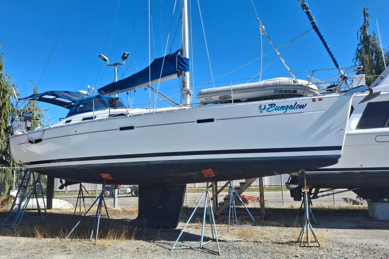Slide: The Image of 2006 Beneteau Oceanis 393 sailboat on stands, blue sky background. - 1
