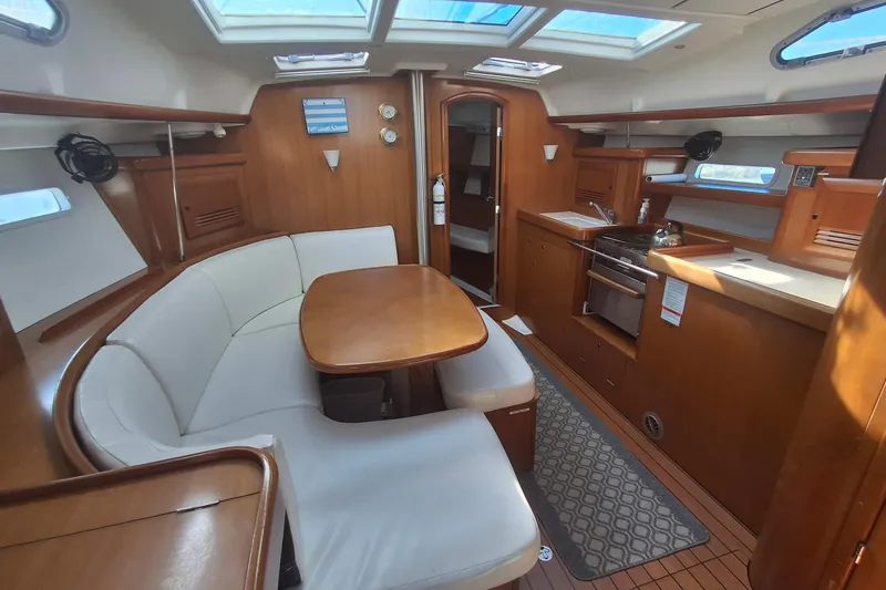 Slide: The Image of Interior of 2006 Beneteau Oceanis 393 sailboat with dining area and kitchen. - 11