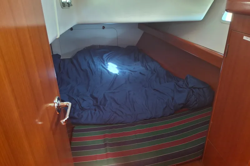 Slide: The Image of Cozy cabin interior of 2006 Beneteau Oceanis 393 sailboat with blue bedding. - 14