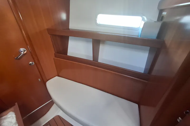 Slide: The Image of Interior of 2006 Beneteau Oceanis 393 sailboat with wooden finish and seating area. - 18