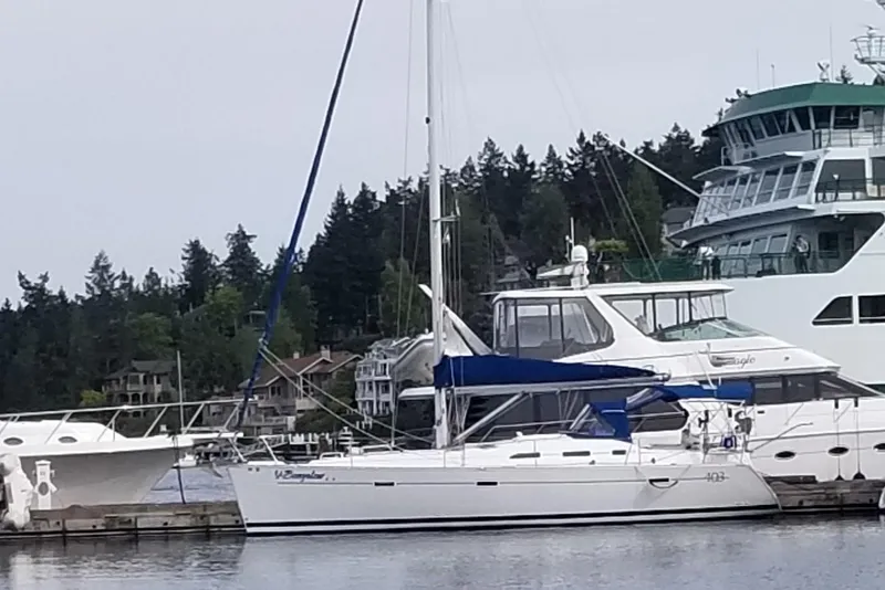 Slide: The Image of 2006 Beneteau Oceanis 393 sailboat docked at marina with other vessels. - 2