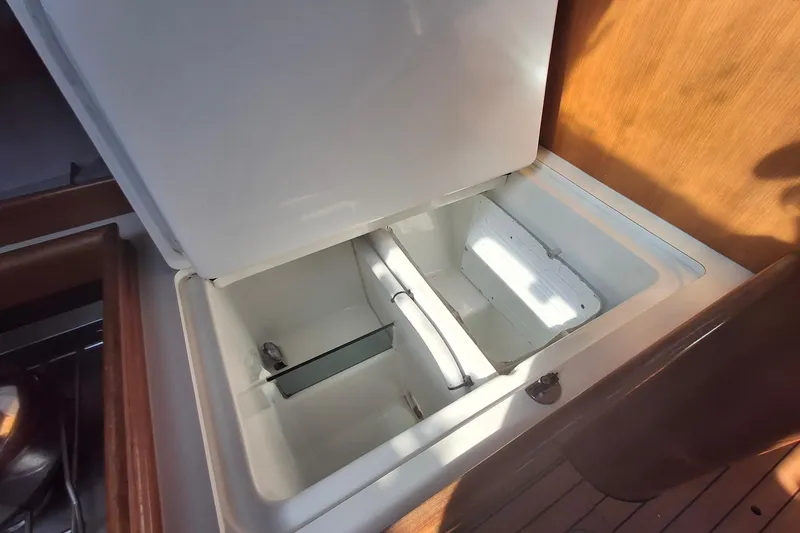 Slide: The Image of Open storage compartment on 2006 Beneteau Oceanis 393 sailboat, featuring wooden interior. - 23