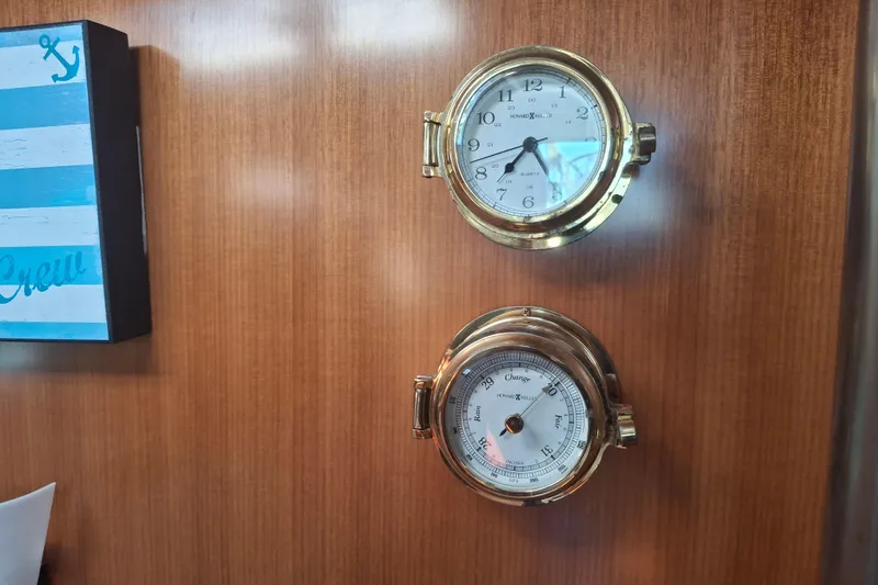 Slide: The Image of Brass clock and barometer on Beneteau Oceanis 393 yacht's wooden interior wall. - 26