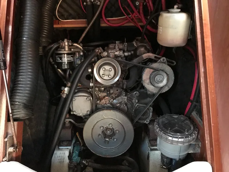 Slide: The Image of Engine compartment of a 2003 Beneteau 411 sailboat, showing belts and hoses. - 14