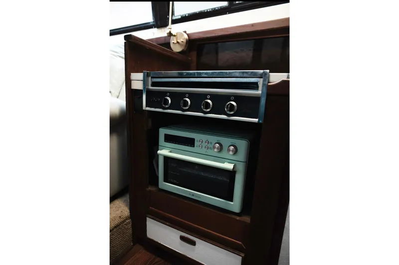 Slide: The Image of 1982 Trojan F-36 Convertible interior with vintage oven and stove setup. - 11