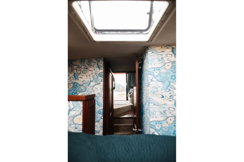 Slide: The Image of Interior view of 1982 Trojan F-36 Convertible boat with floral wallpaper and skylight. - 14