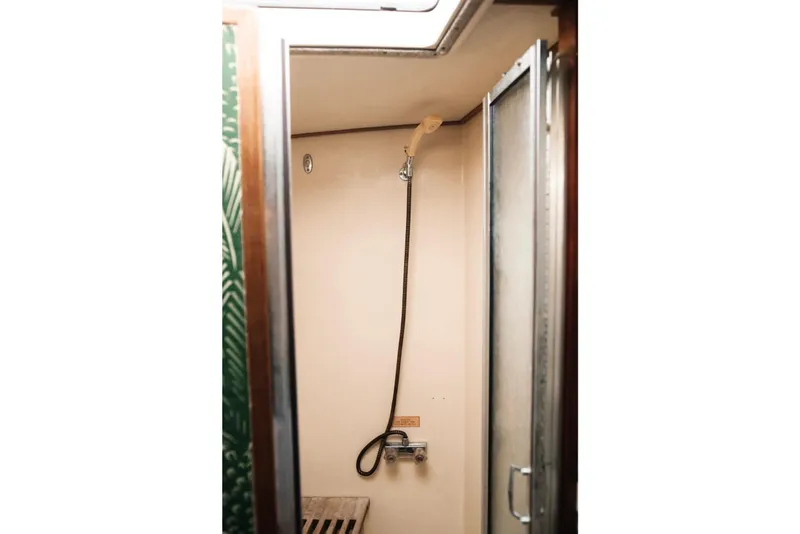 Slide: The Image of Shower area inside 1982 Trojan F-36 Convertible boat, featuring a handheld showerhead. - 17