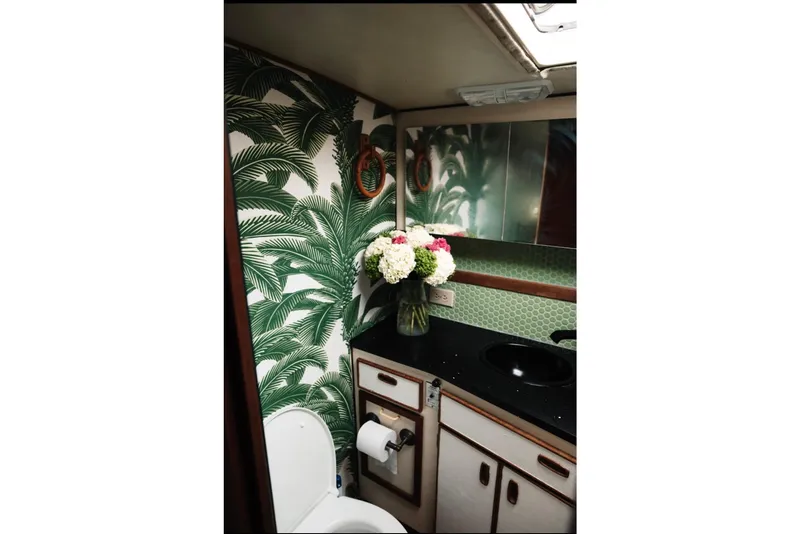 Slide: The Image of Bathroom in 1982 Trojan F-36 Convertible with tropical wallpaper and floral arrangement. - 18