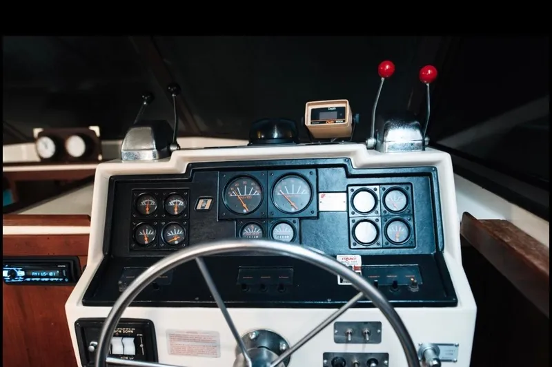 Slide: The Image of 1982 Trojan F-36 Convertible boat dashboard with gauges and steering wheel. - 22