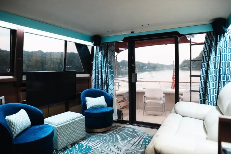 Slide: The Image of Luxurious interior of 1982 Trojan F-36 Convertible yacht with modern decor and river view. - 4