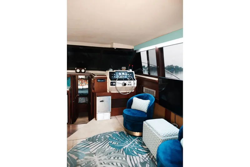 Slide: The Image of Interior of 1982 Trojan F-36 Convertible yacht with plush seating and modern helm. - 6
