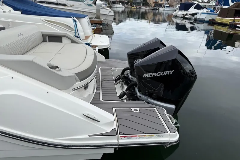 Slide: The Image of 2023 Sea Ray SLX 310 Outboard with dual Mercury engines docked in marina. - 10