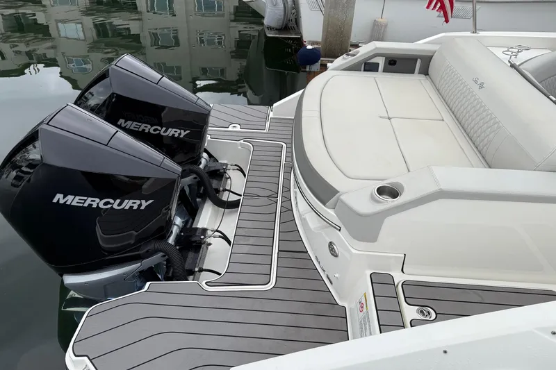 Slide: The Image of 2023 Sea Ray SLX 310 Outboard with dual Mercury engines and luxurious seating. - 11
