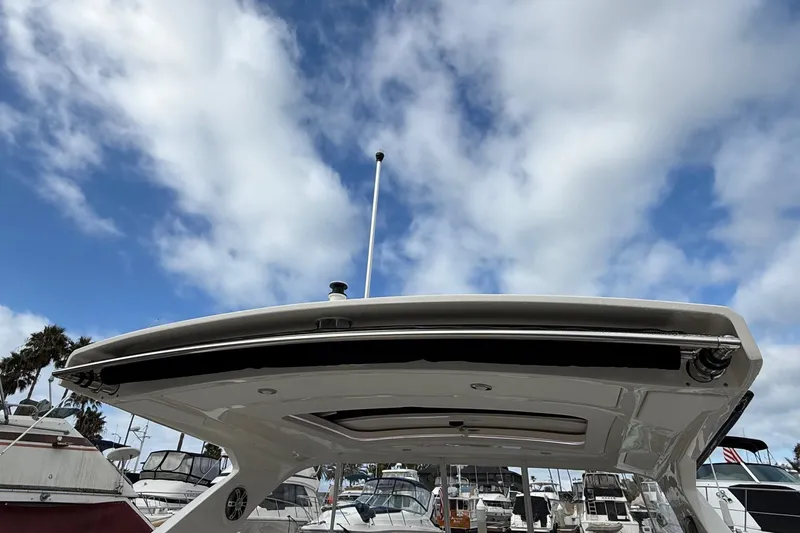 Slide: The Image of 2023 Sea Ray SLX 310 Outboard boat with sleek design under a cloudy sky. - 13