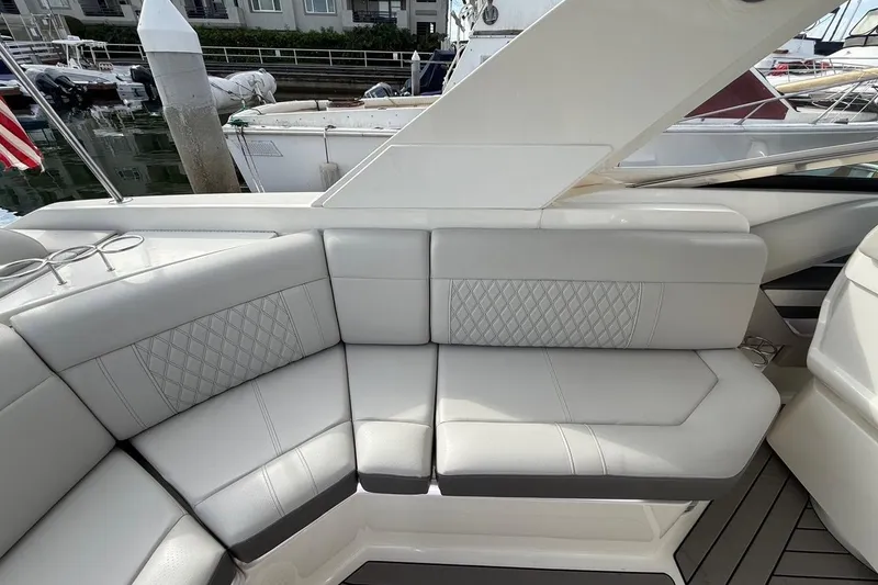 Slide: The Image of Luxurious seating on 2023 Sea Ray SLX 310 Outboard boat, docked at marina. - 26