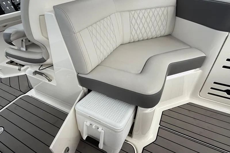 Slide: The Image of 2023 Sea Ray SLX 310 Outboard interior with cushioned seating and integrated storage. - 28