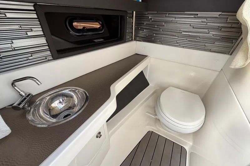 Slide: The Image of 2023 Sea Ray SLX 310 Outboard boat bathroom with sink and toilet. - 34