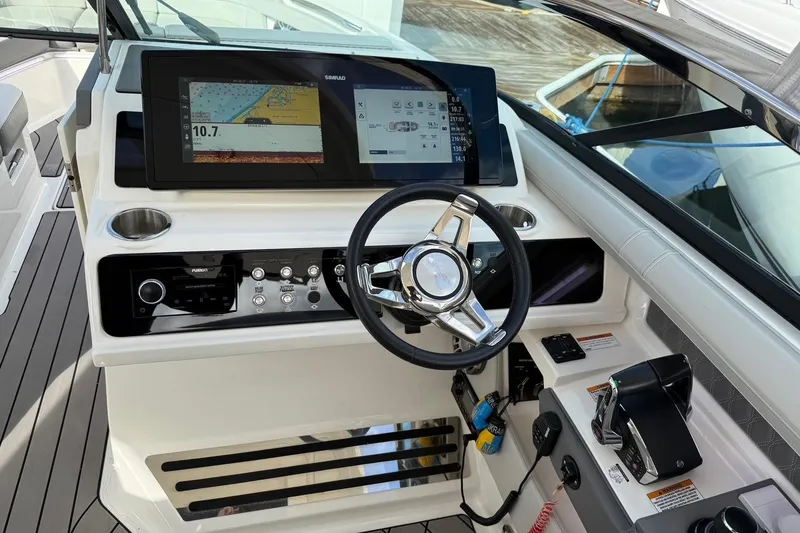 Slide: The Image of 2023 Sea Ray SLX 310 Outboard helm with advanced navigation display and controls. - 35