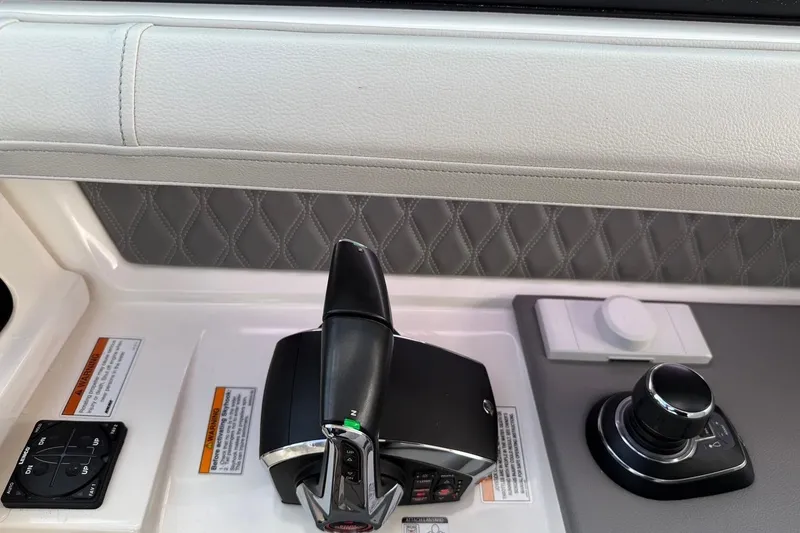 Slide: The Image of 2023 Sea Ray SLX 310 Outboard control panel with joystick and throttle. - 37