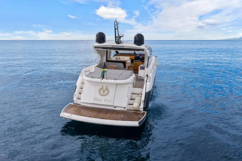 Slide: The Image of 2019 Sunseeker Predator 57 yacht cruising on open water under a clear blue sky. - 15
