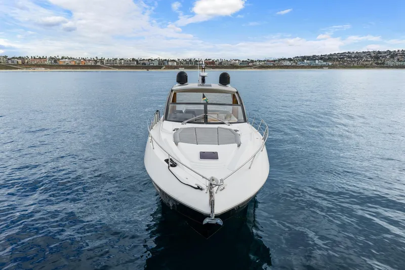 Slide: The Image of 2019 Sunseeker Predator 57 yacht on calm waters under a blue sky. - 19