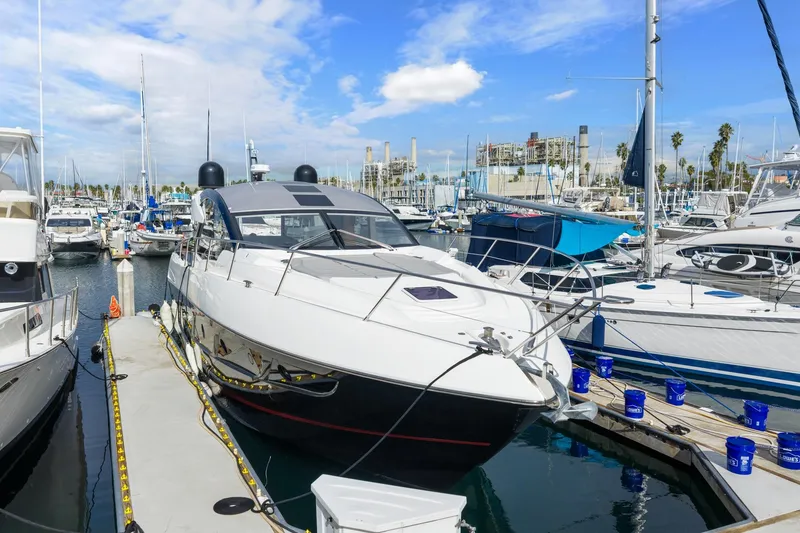 Slide: The Image of 2019 Sunseeker Predator 57 yacht on calm blue water, coastal background. - 21