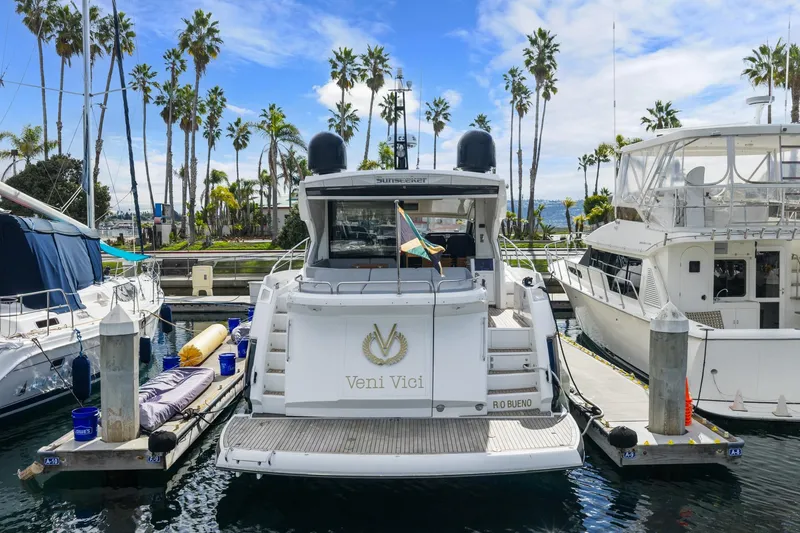 Slide: The Image of 2019 Sunseeker Predator 57 yacht docked in a marina under a clear blue sky. - 23