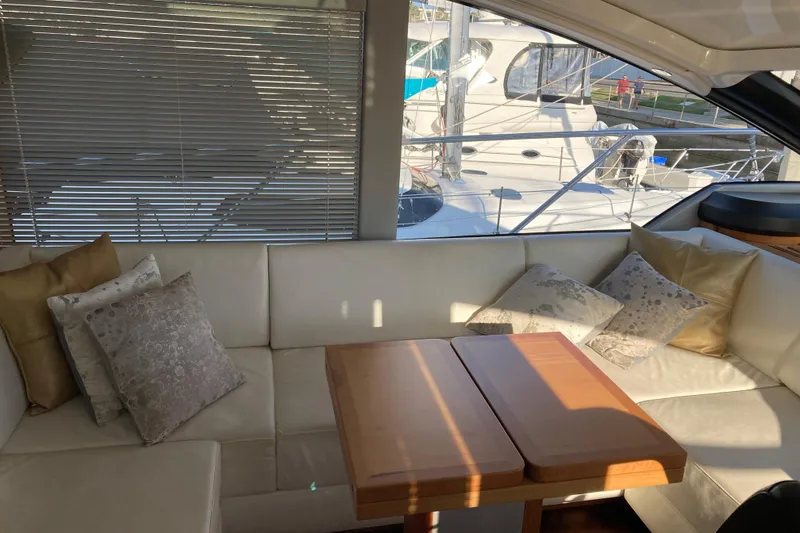 Slide: The Image of 2019 Sunseeker Predator 57 yacht on calm waters with scenic coastal backdrop. - 3