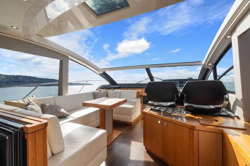 Slide: The Image of Interior view of 2019 Sunseeker Predator 57 yacht, featuring luxurious seating and helm. - 30
