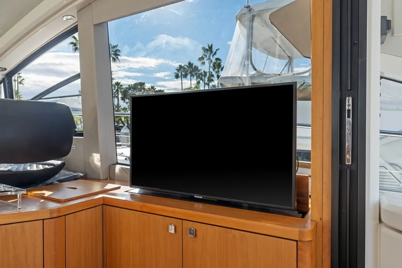 Slide: The Image of 2019 Sunseeker Predator 57 yacht deck with ocean view and flag. - 35