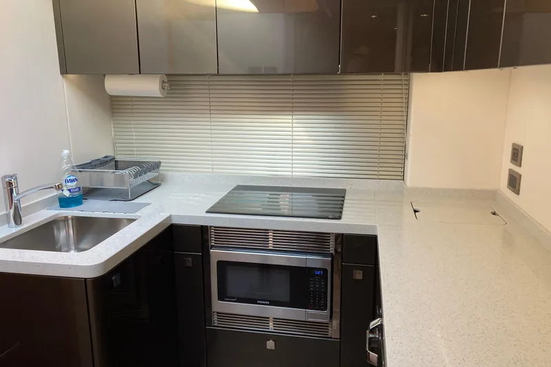 Slide: The Image of 2019 Sunseeker Predator 57 yacht cruising on open water under a clear blue sky. - 5