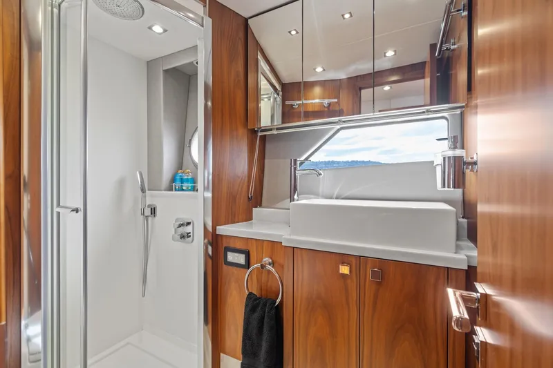 Slide: The Image of Luxurious bathroom in 2019 Sunseeker Predator 57 yacht with modern fixtures and wood accents. - 51