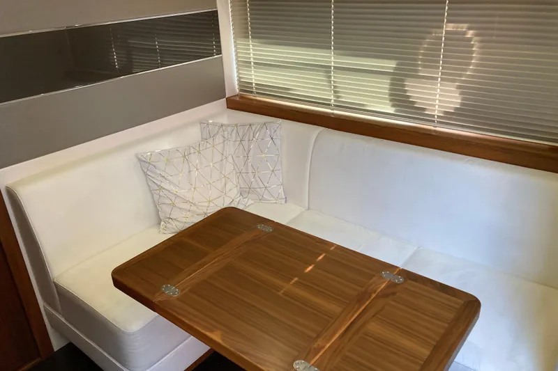 Slide: The Image of 2019 Sunseeker Predator 57 yacht cruising in a scenic coastal area. - 9