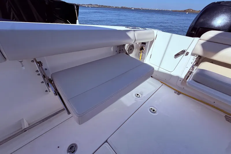 Slide: The Image of 2020 Boston Whaler 350 Outrage boat interior with foldable seating and ocean view. - 11
