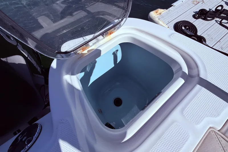 Slide: The Image of Open storage compartment on a 2020 Boston Whaler 350 Outrage boat. - 12