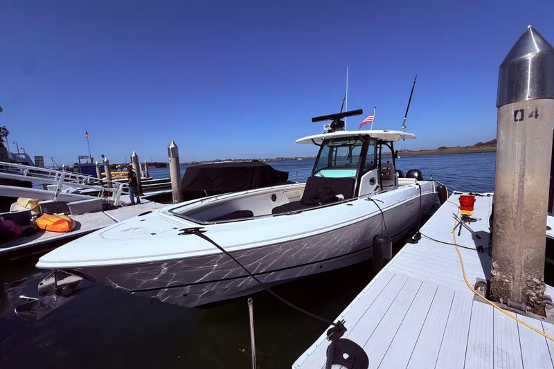 Slide: The Image of 2020 Boston Whaler 350 Outrage docked at marina under clear blue sky. - 5