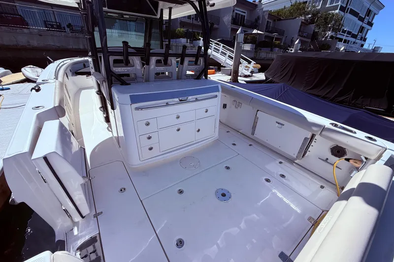 Slide: The Image of 2020 Boston Whaler 350 Outrage boat interior with seating and storage compartments. - 7