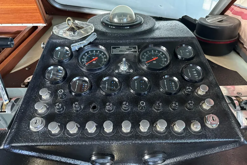 Slide: The Image of Control panel of a 1984 Tollycraft 34 aft cabin boat with gauges and switches. - 13