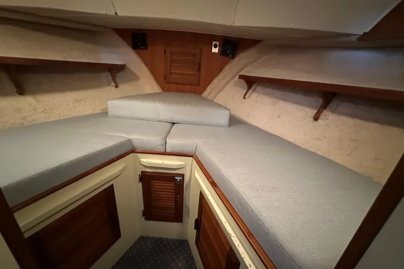 Slide: The Image of 1984 Tollycraft 34 aft cabin interior with cozy V-berth and wooden accents. - 18