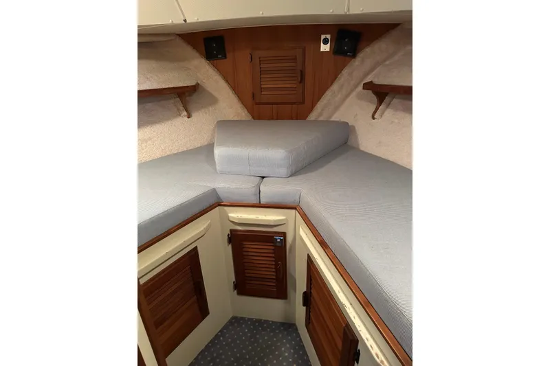 Slide: The Image of 1984 Tollycraft 34 aft cabin interior with cushioned seating and wooden cabinetry. - 19