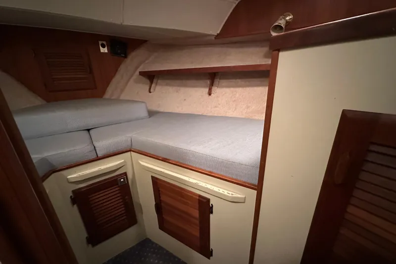 Slide: The Image of 1984 Tollycraft 34 aft cabin interior with cozy bed and wooden cabinets. - 20
