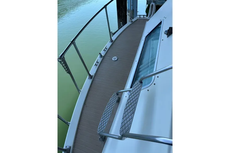 Slide: The Image of 1984 Tollycraft 34 aft cabin boat deck with railing and window view. - 26