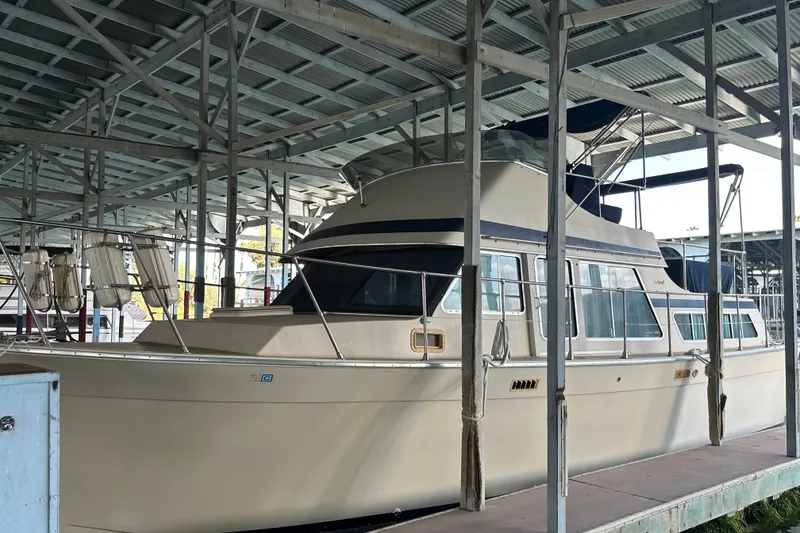 Slide: The Image of 1984 Tollycraft 34 aft cabin yacht docked in covered marina. - 29