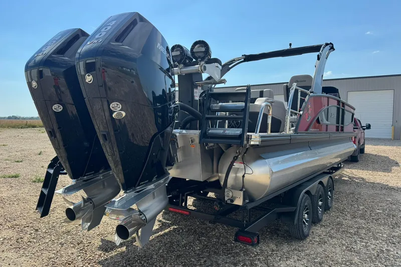Slide: The Image of 2025 Barletta LUSSO 25UCAT pontoon boat with dual Mercury outboard engines on a trailer. - 11