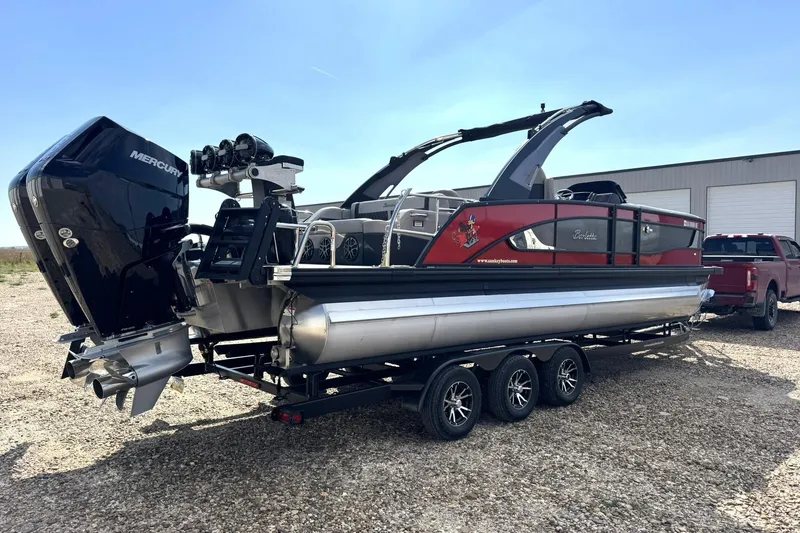 Slide: The Image of 2025 Barletta LUSSO 25UCAT pontoon boat on trailer, featuring Mercury outboard engine. - 12
